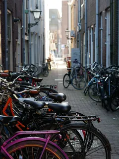 Fietsen langs smal, met baksteen geplaveid steegje in Nederland